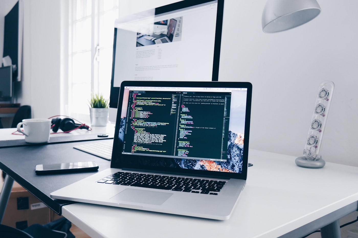 A developer's workspace with code open across two screens
