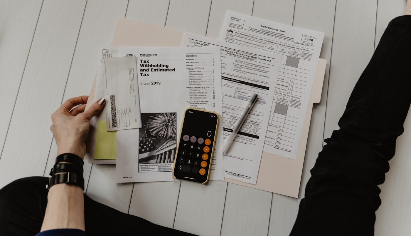 A desk covered in financial documents being reconciled