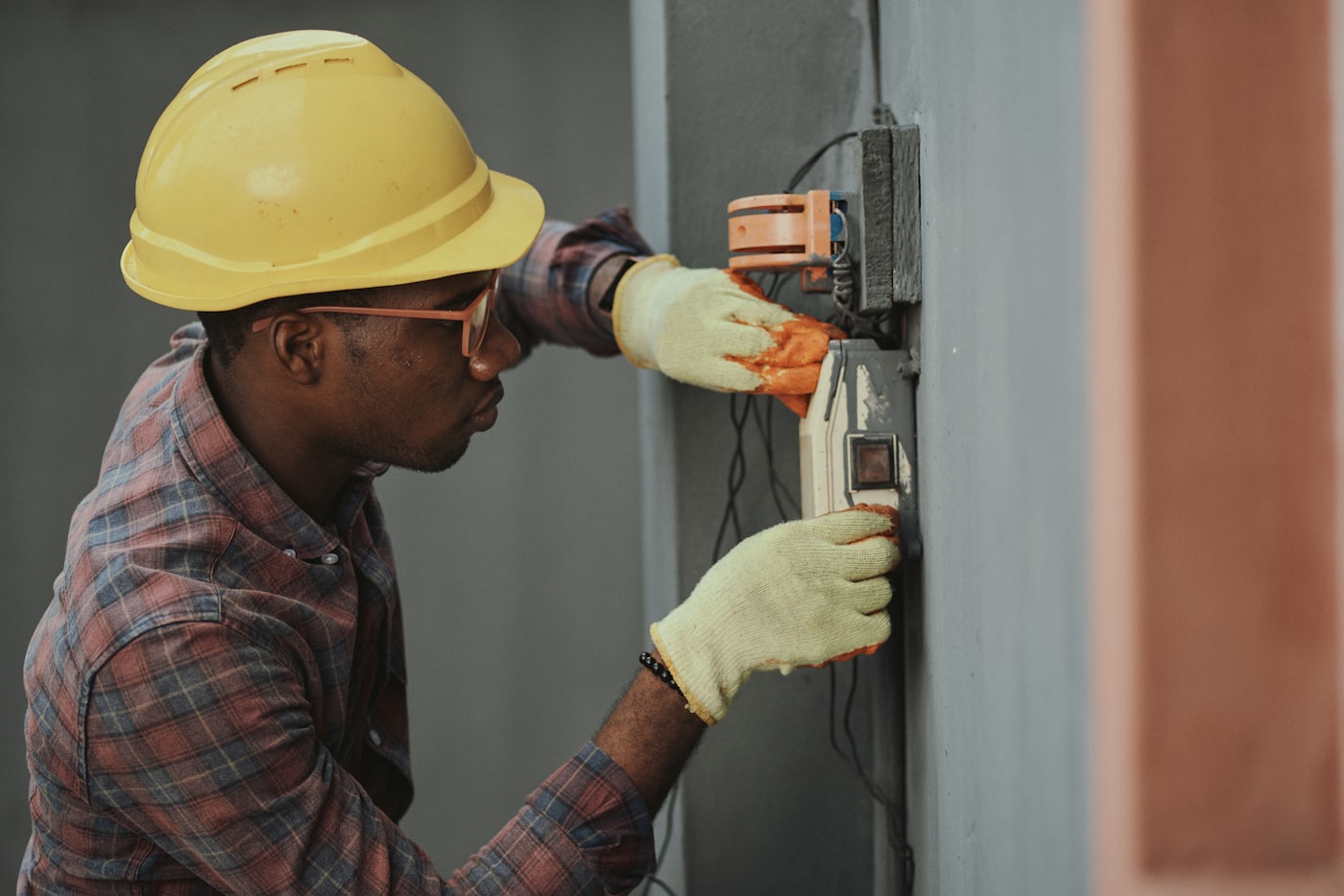 A technician in a hard hat responding to an equipment alert