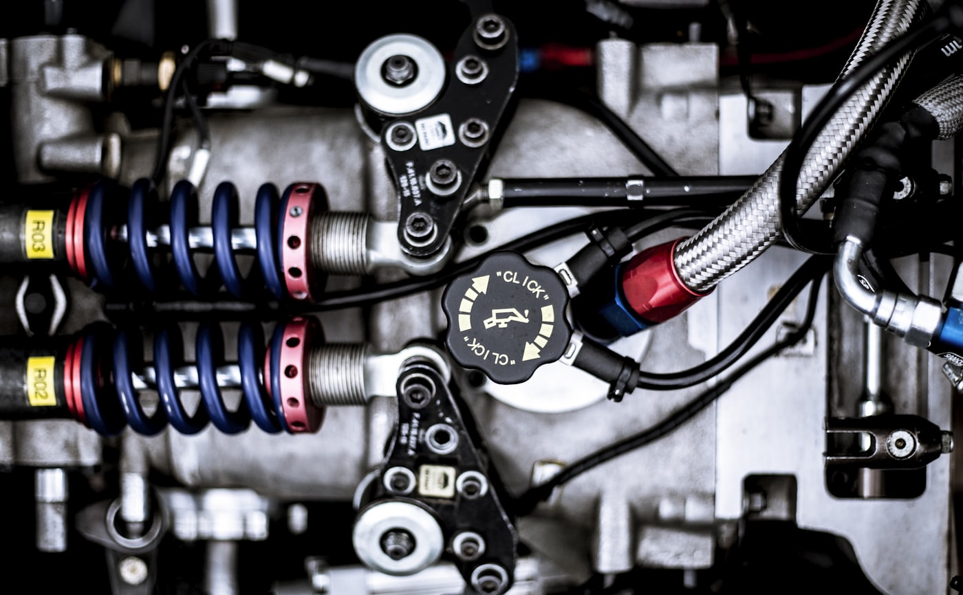 Close-up of industrial machinery with suspension springs and hydraulic lines